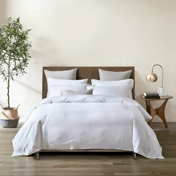 Bianca duvet cover set in white with intricately woven medallion matelassé design and 300 thread count cotton sateen reverse