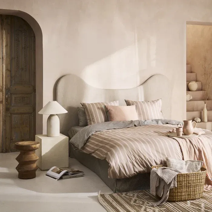 Martini olive and natural striped duvet cover in 100% cotton on a styled bed